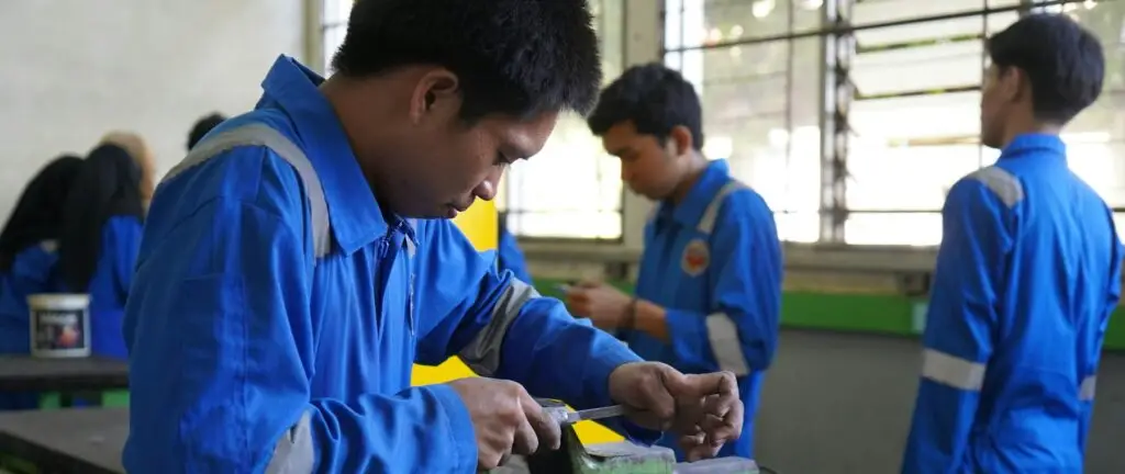A group of people working together on a metal fabrication